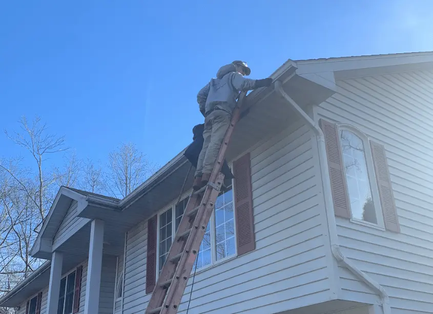Gutter cleaning and maintenance being performed by Beachwood Power Washing in Beachwood